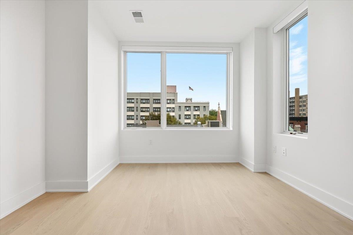303 Madison Street, Unit 406 Hoboken, NJ 07030 - Photo 9 of 29 a view of an empty room with a window