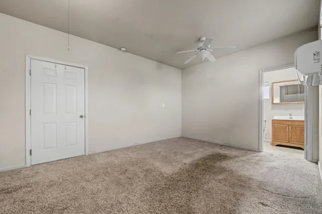 a view of kitchen with granite countertop cabinets and sink