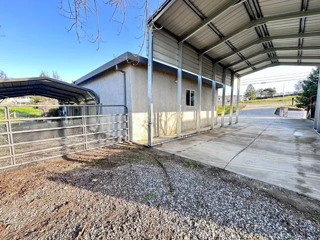 an aerial view of a house with pool big yard and large tree