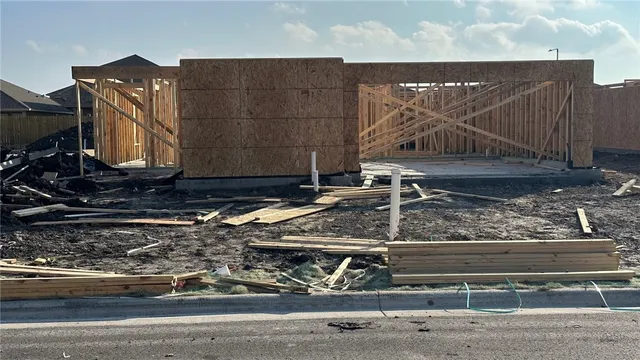 a view of street with wooden fence
