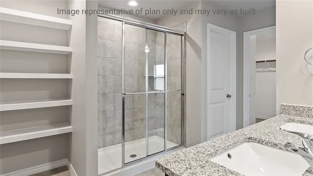 a bathroom with a shower and a sink