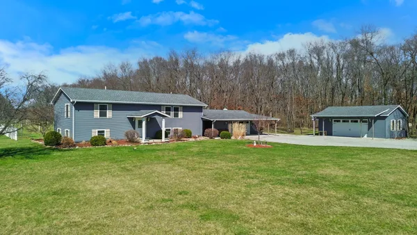 a front view of house with yard and trees