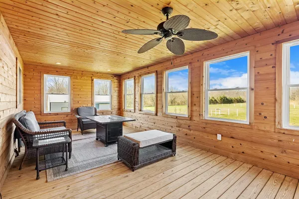 a view of a bedroom with furniture and a window