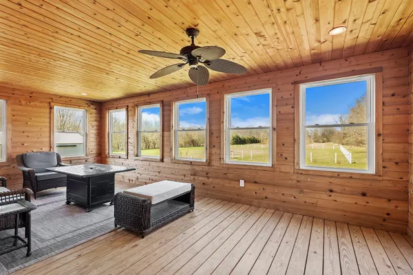 a front view of a house with a yard and trees
