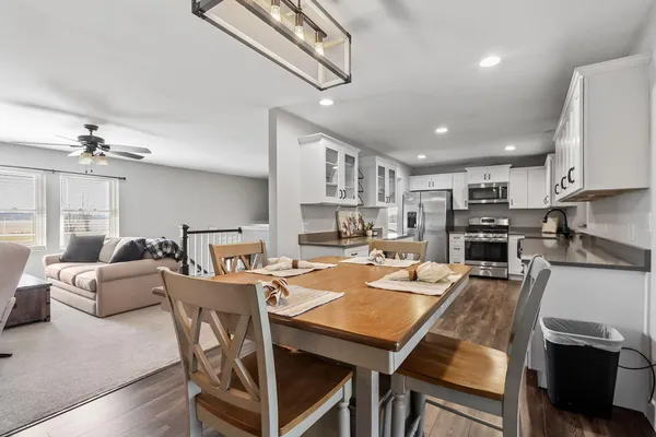 a front view of house with yard and trees in the background