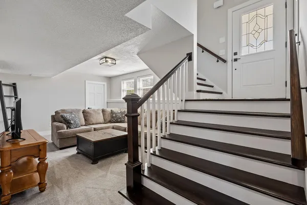 an aerial view of a house with a garden and lake view