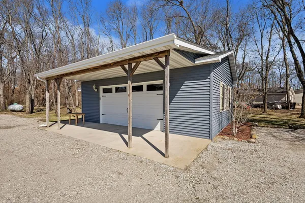 a front view of house with yard and garage