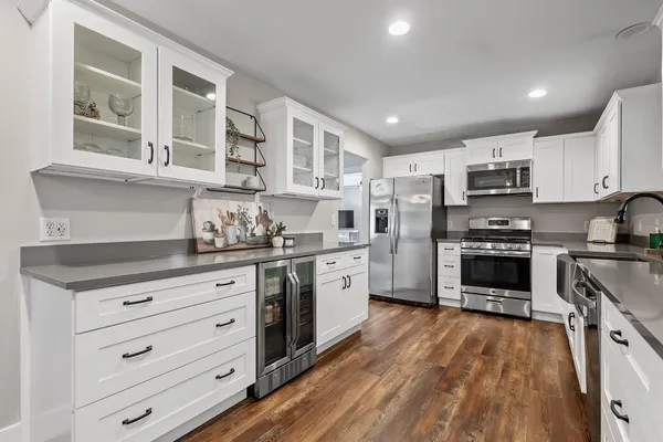 a spacious bedroom with a bed and ceiling fan