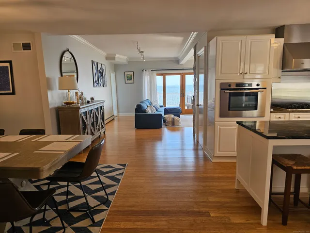 a living room with fireplace furniture and a wooden floor