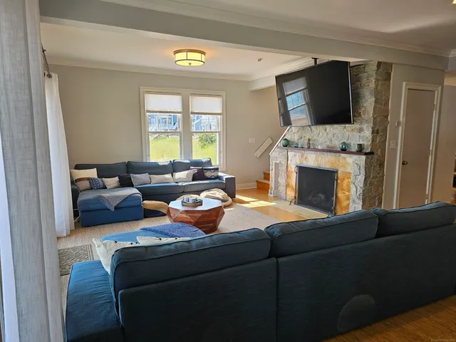 a living room with furniture fireplace and flat screen tv