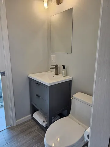 a white toilet sitting next to a bathroom sink