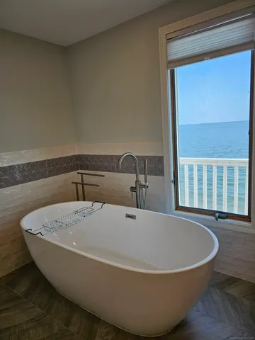 a white bath tub sitting next to a window