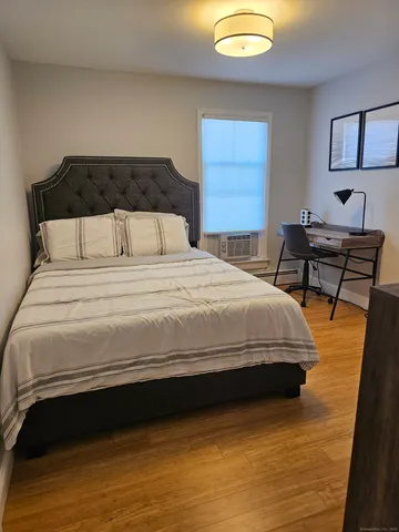 a bedroom with a bed and a desk