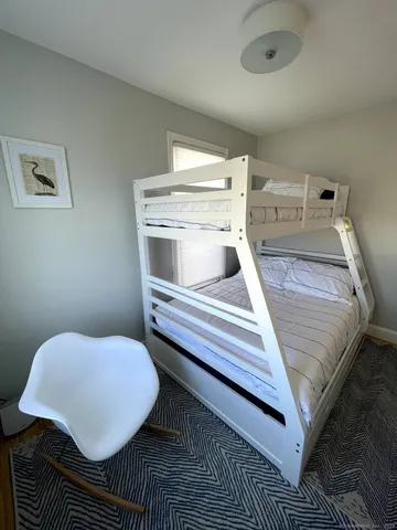 a bedroom with a bed and a table
