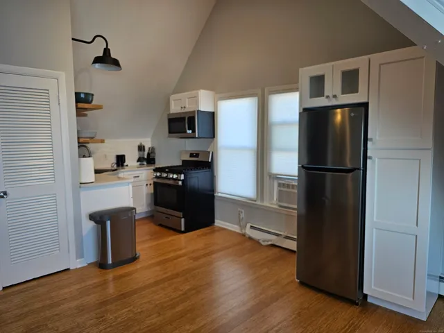 a kitchen with a refrigerator and a stove top oven