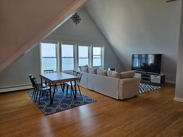 a living room with furniture dining table and a flat screen tv