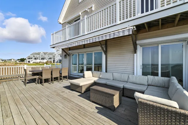 a view of a patio with couches chairs and wooden floor