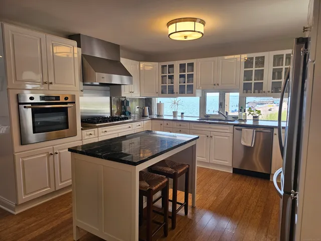 a kitchen with a sink stove and microwave