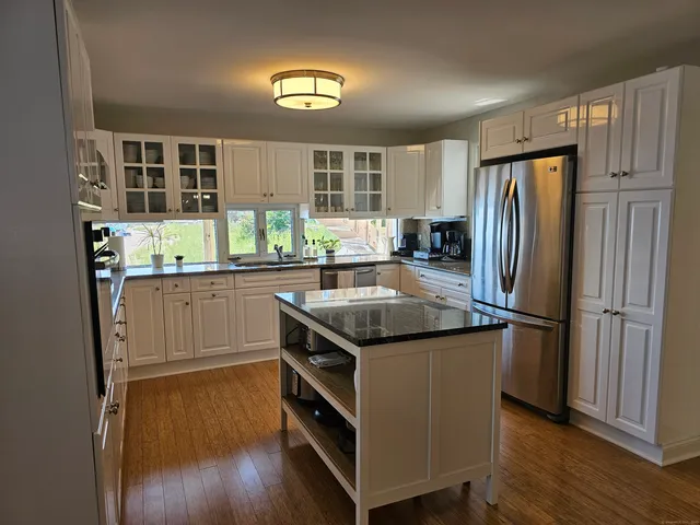 a kitchen with a stove a refrigerator and a sink
