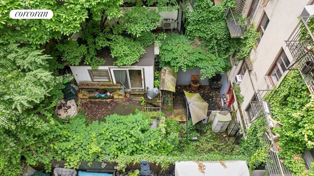 a view of a backyard with plants and a patio