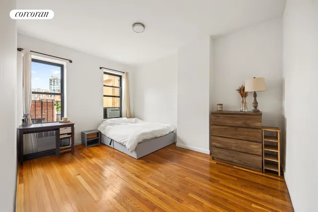 a living room with furniture wooden floor and a flat screen tv
