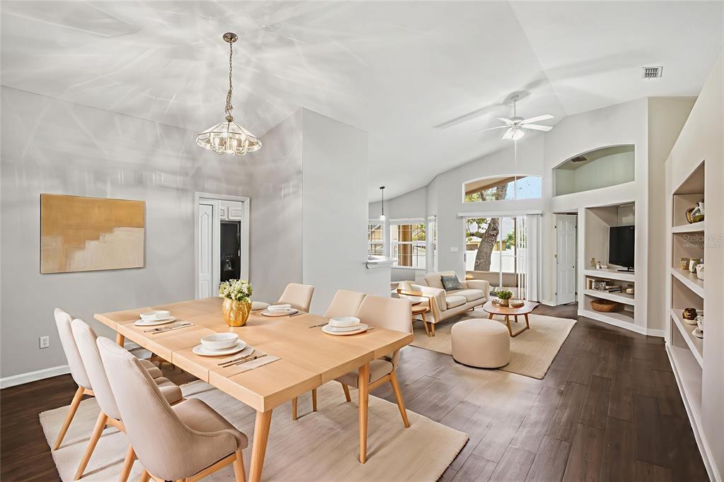 2834 Mayflower Loop Clermont, FL 34714 - Photo 3 of 28 a view of a dining room and livingroom with furniture wooden floor a chandelier
