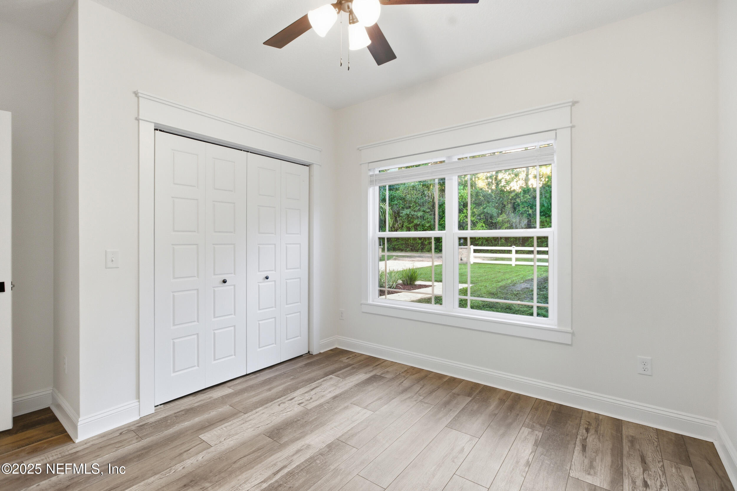 128 Santa Rosa Street Florahome, FL 32140 - Photo 12 of 57 wooden floor in an empty room with a window