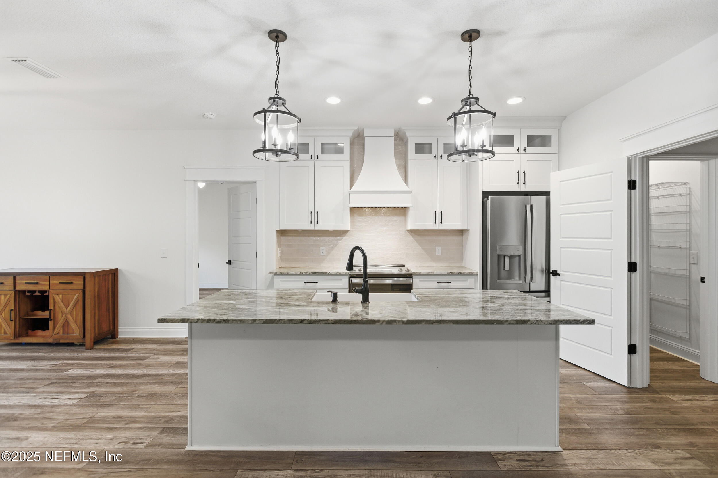 128 Santa Rosa Street Florahome, FL 32140 - Photo 16 of 57 a large kitchen with granite countertop a stove a sink dishwasher a refrigerator and wooden floor