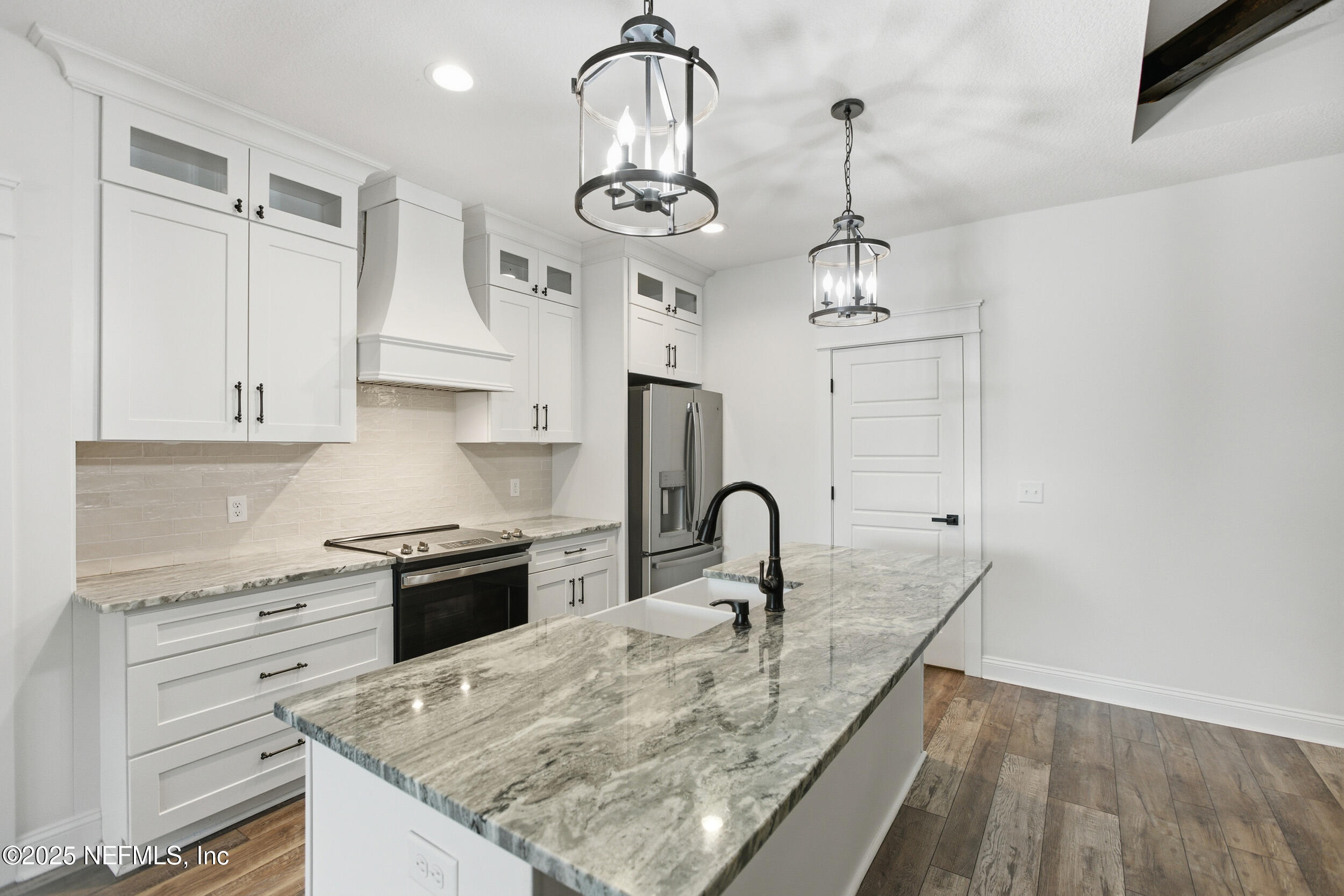 128 Santa Rosa Street Florahome, FL 32140 - Photo 18 of 57 a kitchen with stainless steel appliances granite countertop a sink a stove and a refrigerator