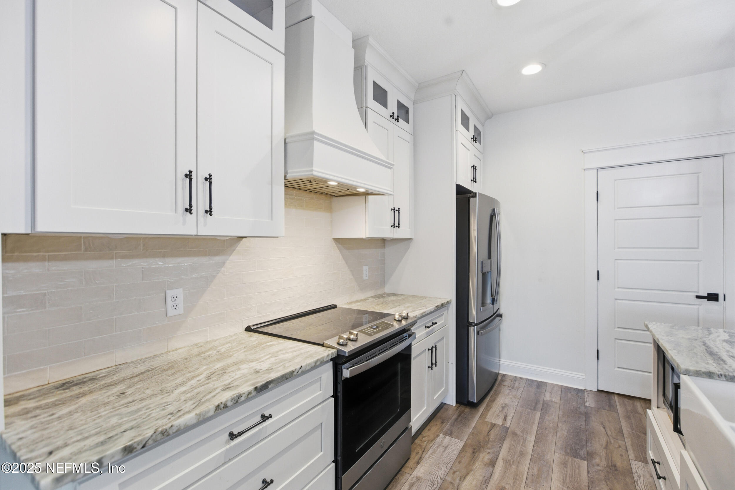 128 Santa Rosa Street Florahome, FL 32140 - Photo 19 of 57 a kitchen with stainless steel appliances granite countertop a stove and a refrigerator