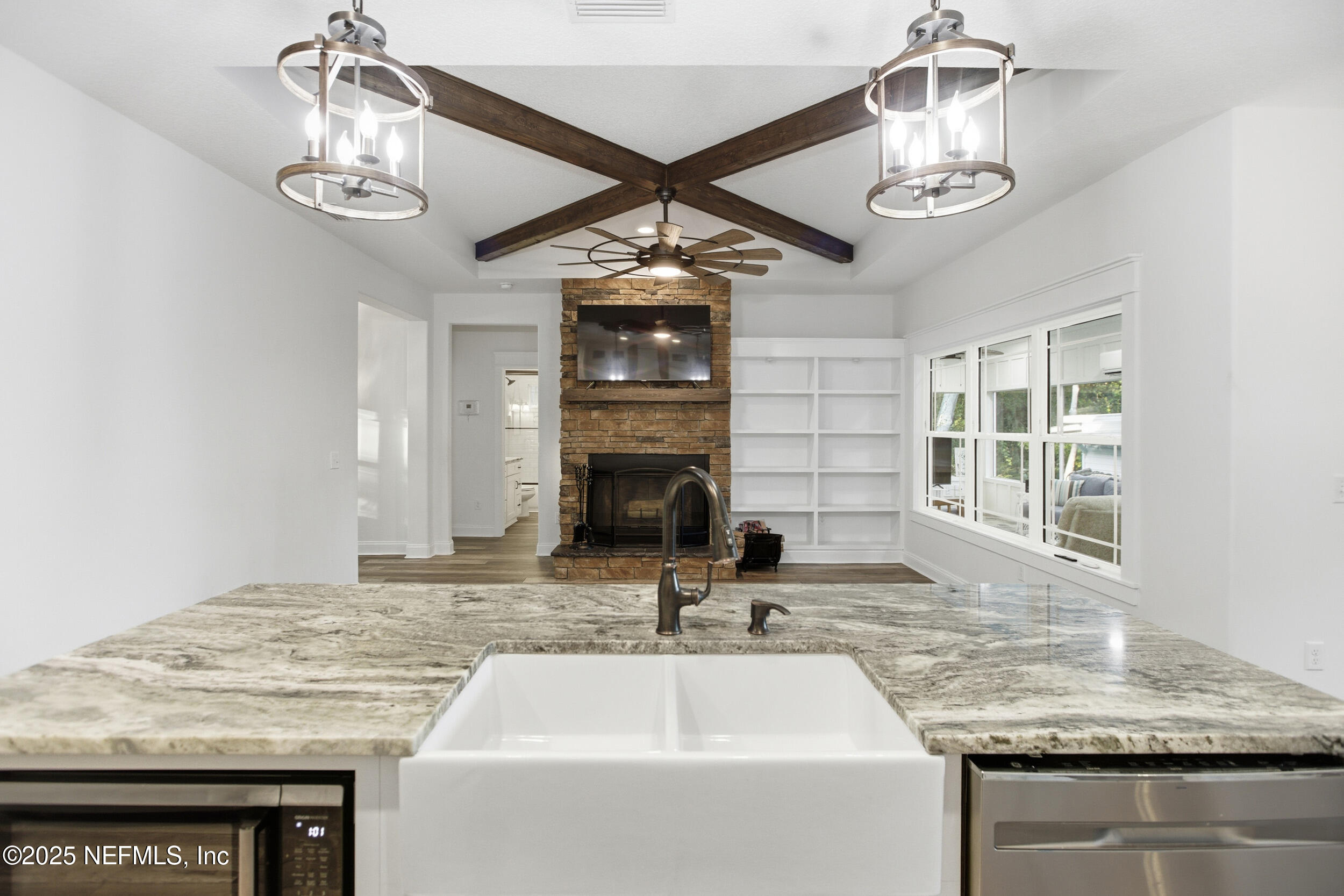 128 Santa Rosa Street Florahome, FL 32140 - Photo 20 of 57 a kitchen with kitchen island granite countertop a sink and chandelier