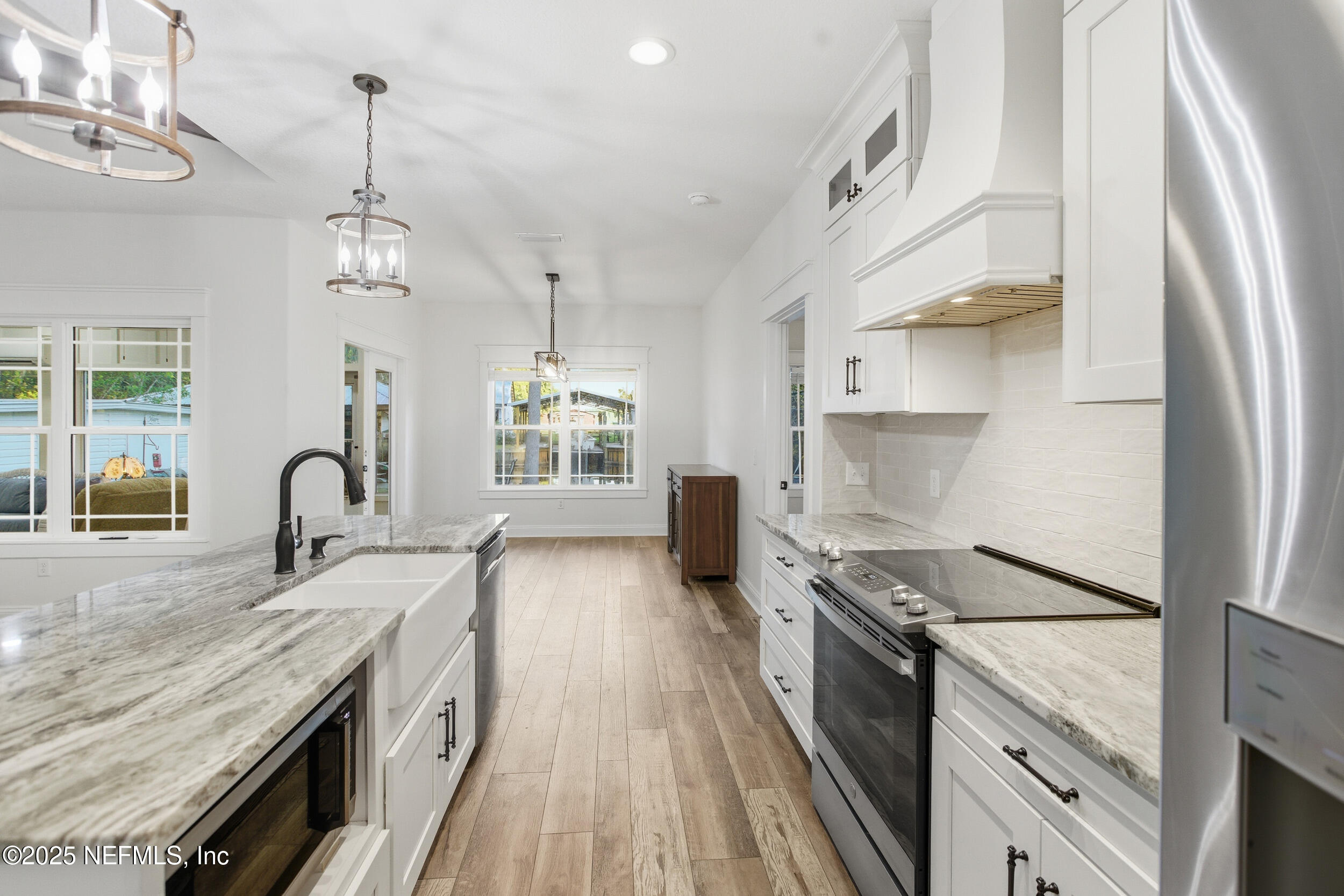 128 Santa Rosa Street Florahome, FL 32140 - Photo 24 of 57 a kitchen with granite countertop a stove and a sink