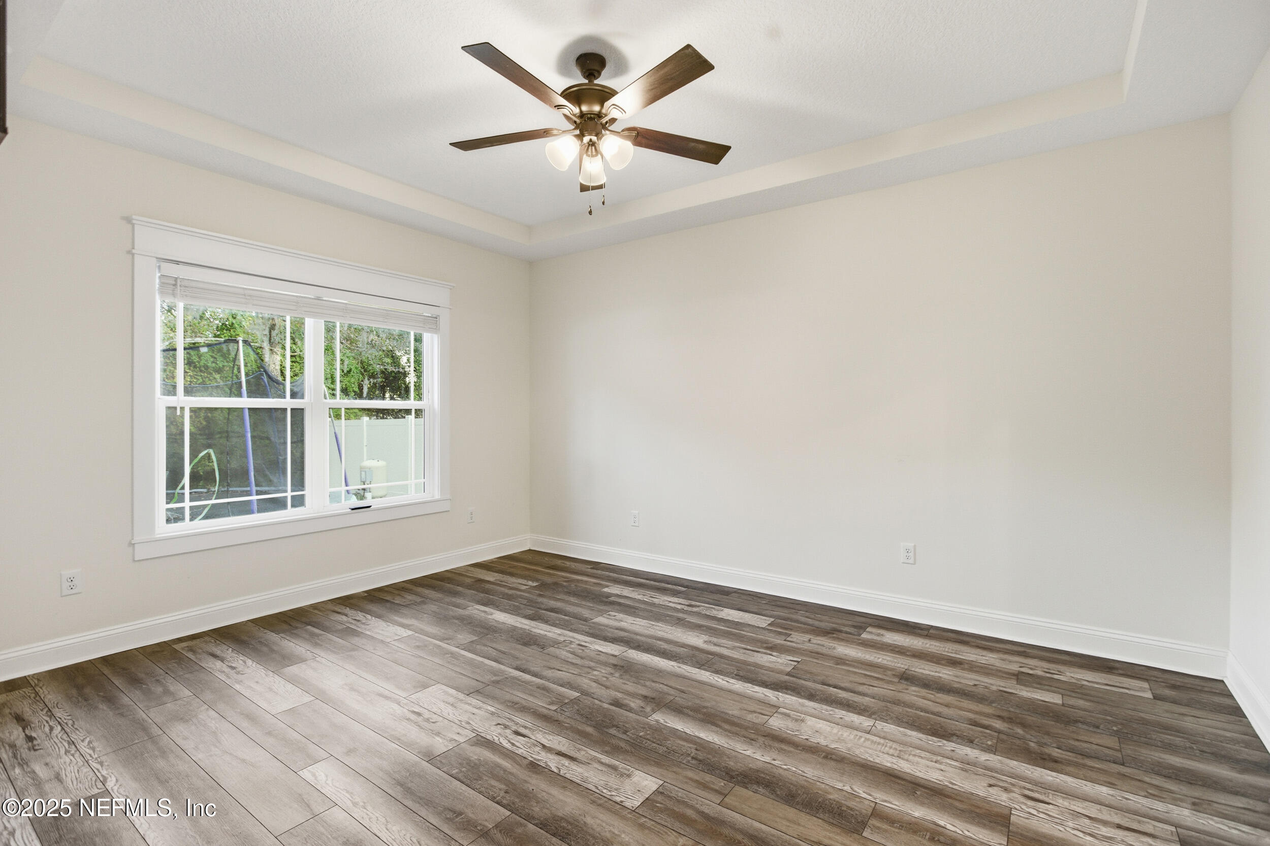 128 Santa Rosa Street Florahome, FL 32140 - Photo 28 of 57 an empty room with wooden floor and windows