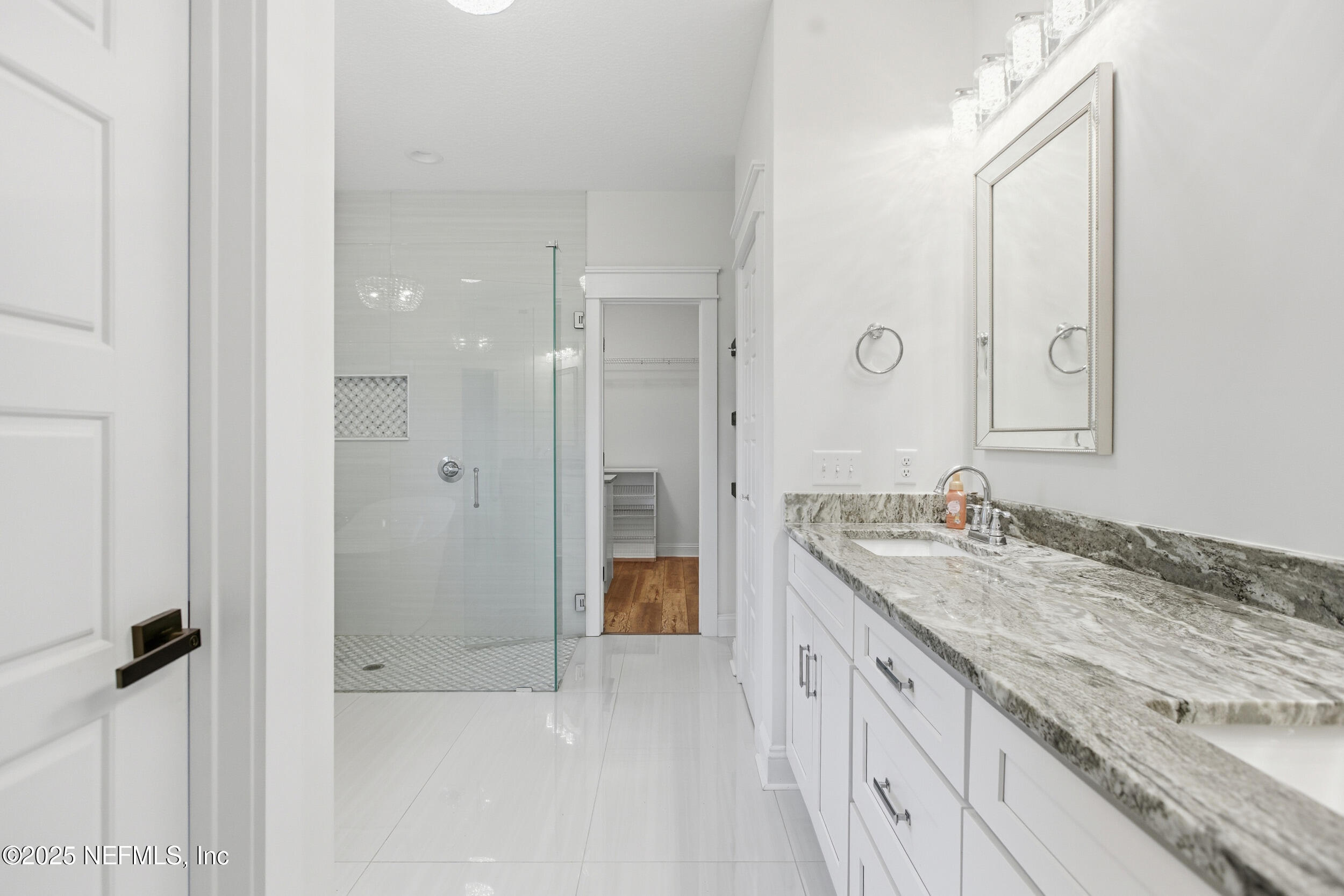 128 Santa Rosa Street Florahome, FL 32140 - Photo 29 of 57 a spacious bathroom with a granite countertop sink mirror and double