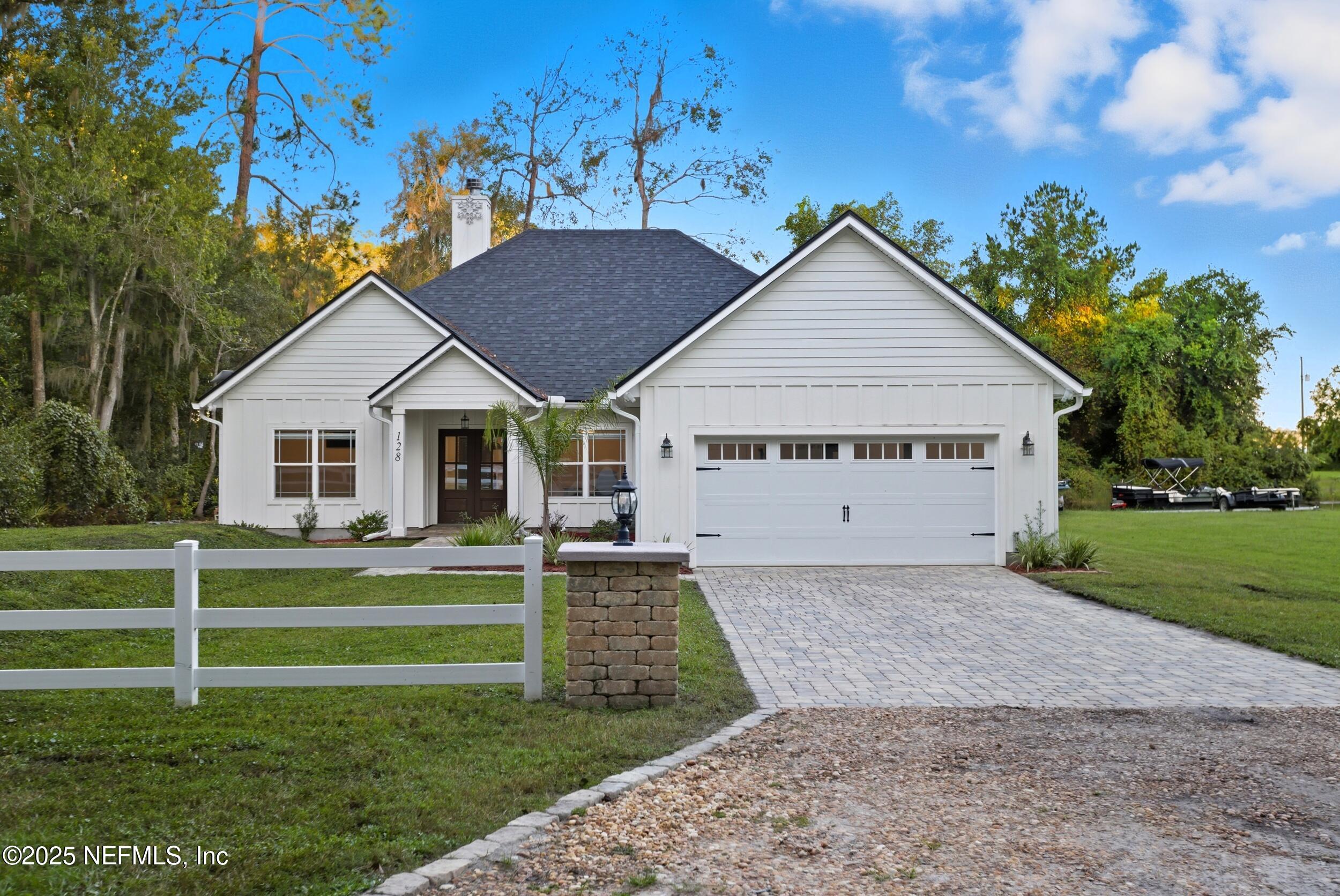 128 Santa Rosa Street Florahome, FL 32140 - Photo 3 of 57 a view of a house with a yard and fence