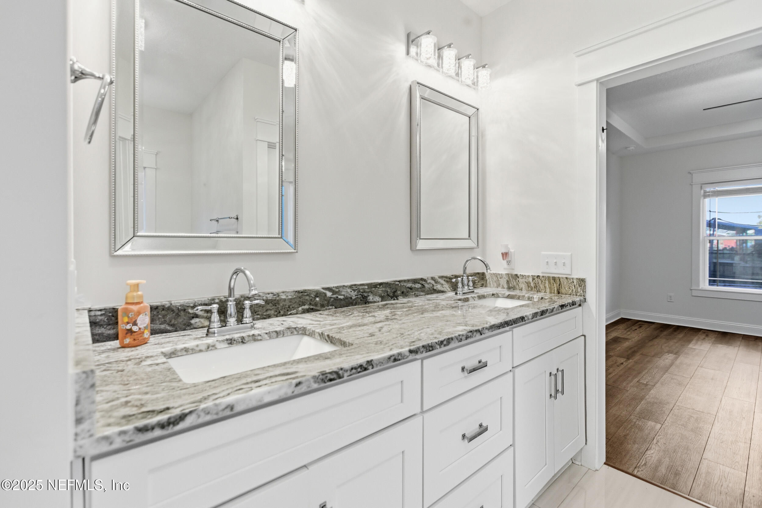 128 Santa Rosa Street Florahome, FL 32140 - Photo 31 of 57 a bathroom with a granite countertop sink and a mirror