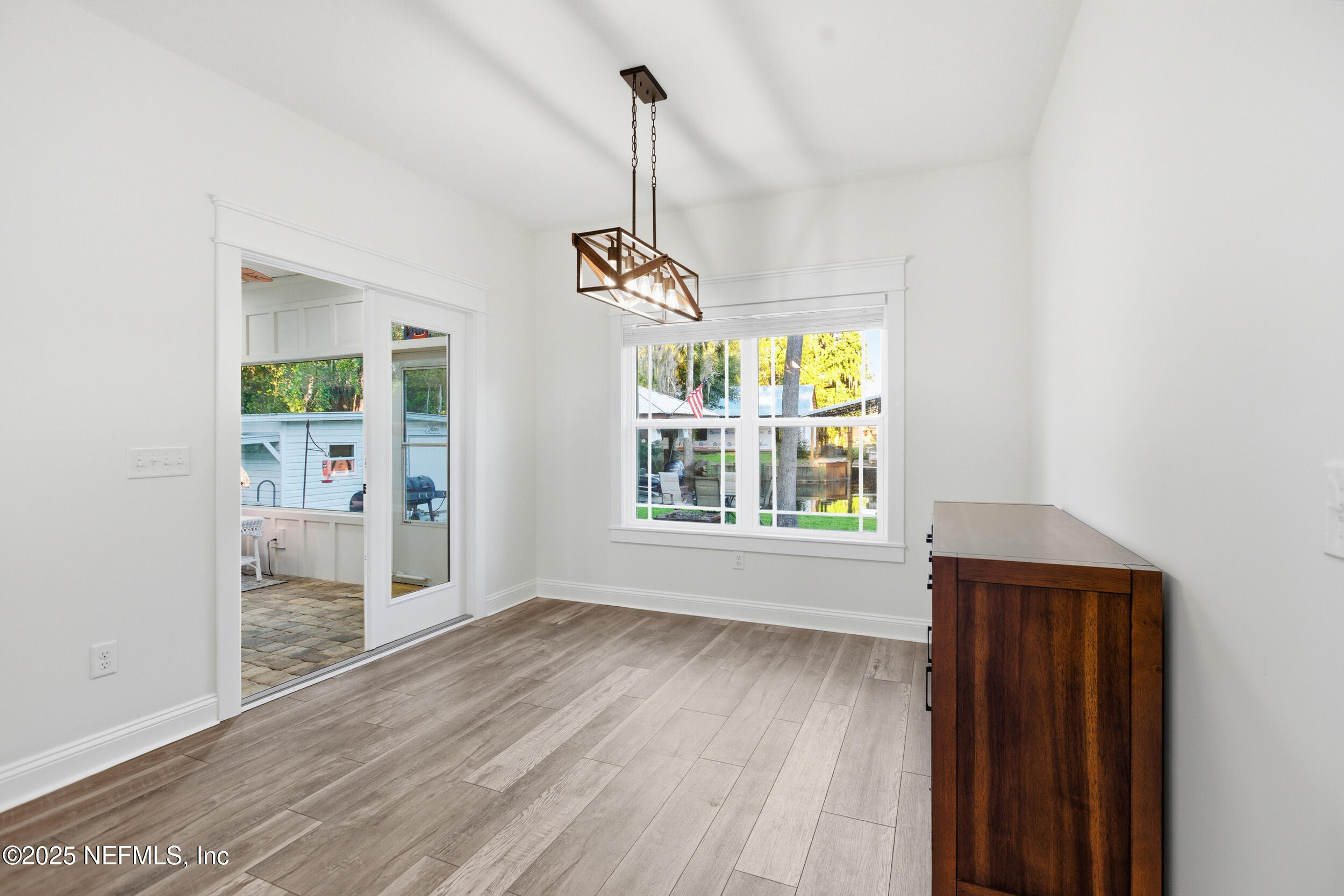 128 Santa Rosa Street Florahome, FL 32140 - Photo 34 of 57 a view of an empty room with window and wooden floor
