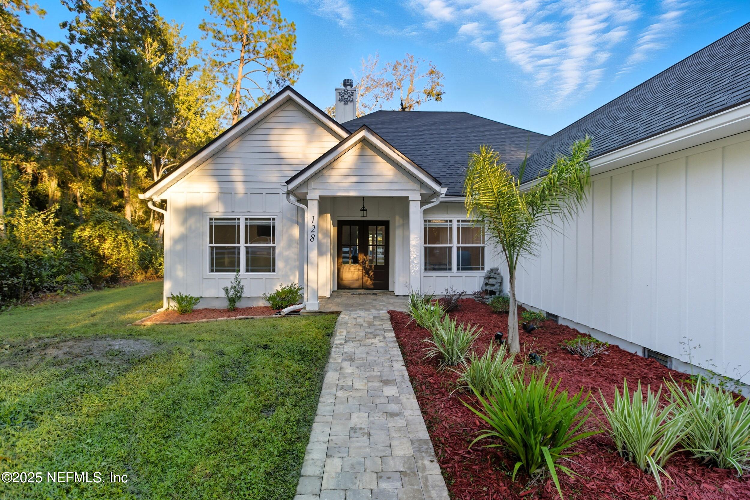 128 Santa Rosa Street Florahome, FL 32140 - Photo 4 of 57 a front view of a house with a yard