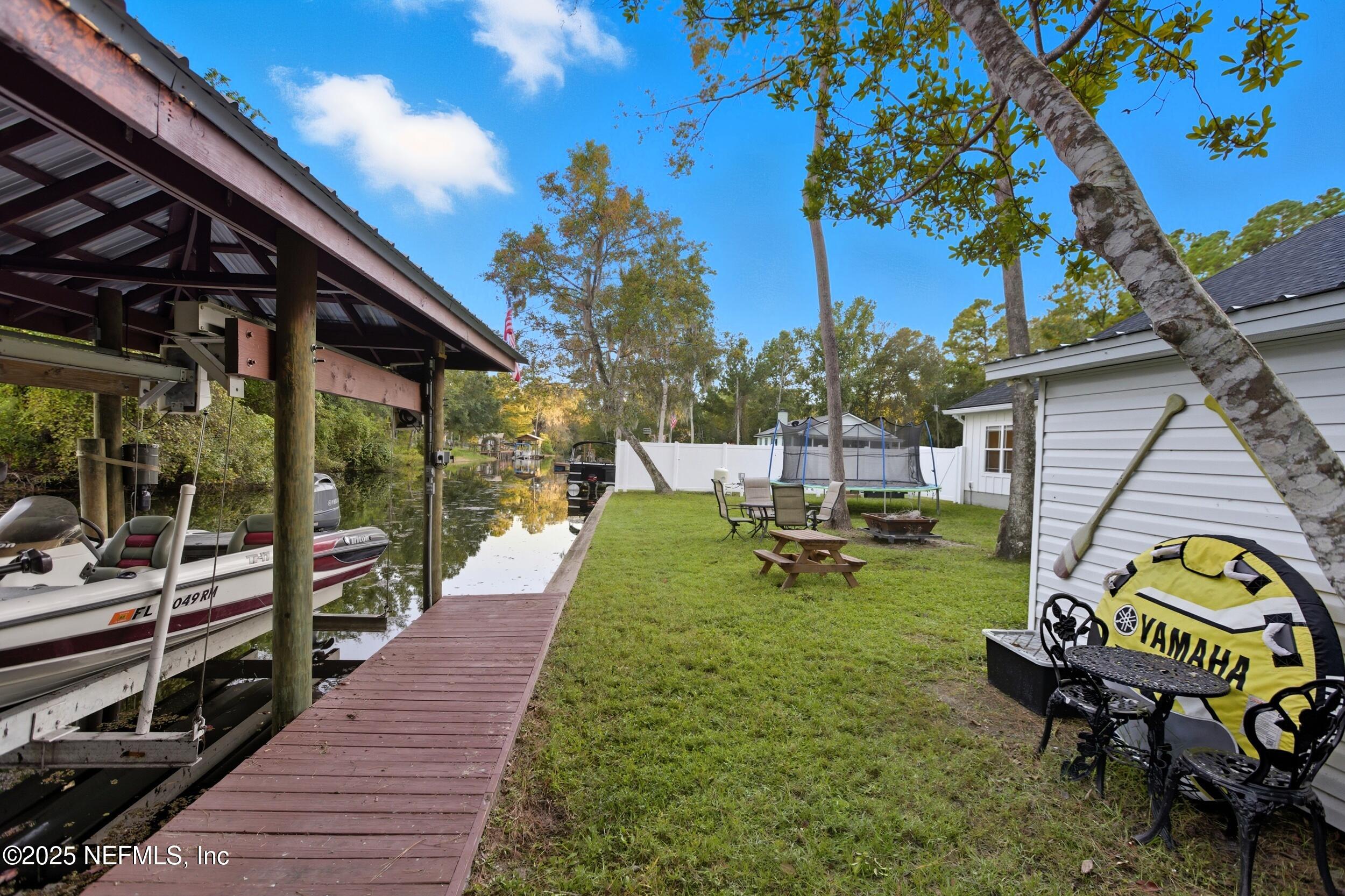 128 Santa Rosa Street Florahome, FL 32140 - Photo 44 of 57 a backyard of a house with table and chairs