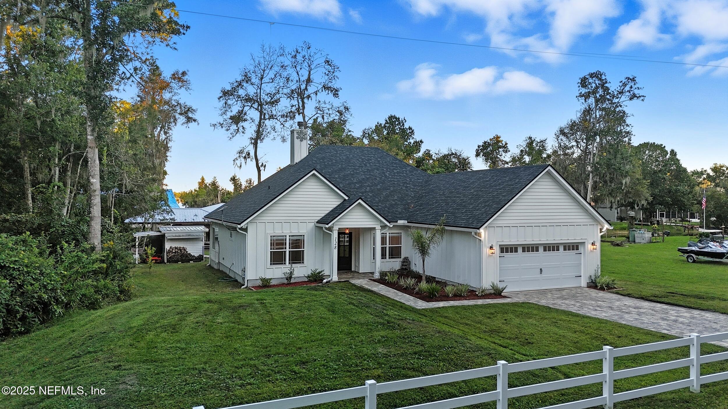 128 Santa Rosa Street Florahome, FL 32140 - Photo 52 of 57 a view of a house with a big yard plants and large trees