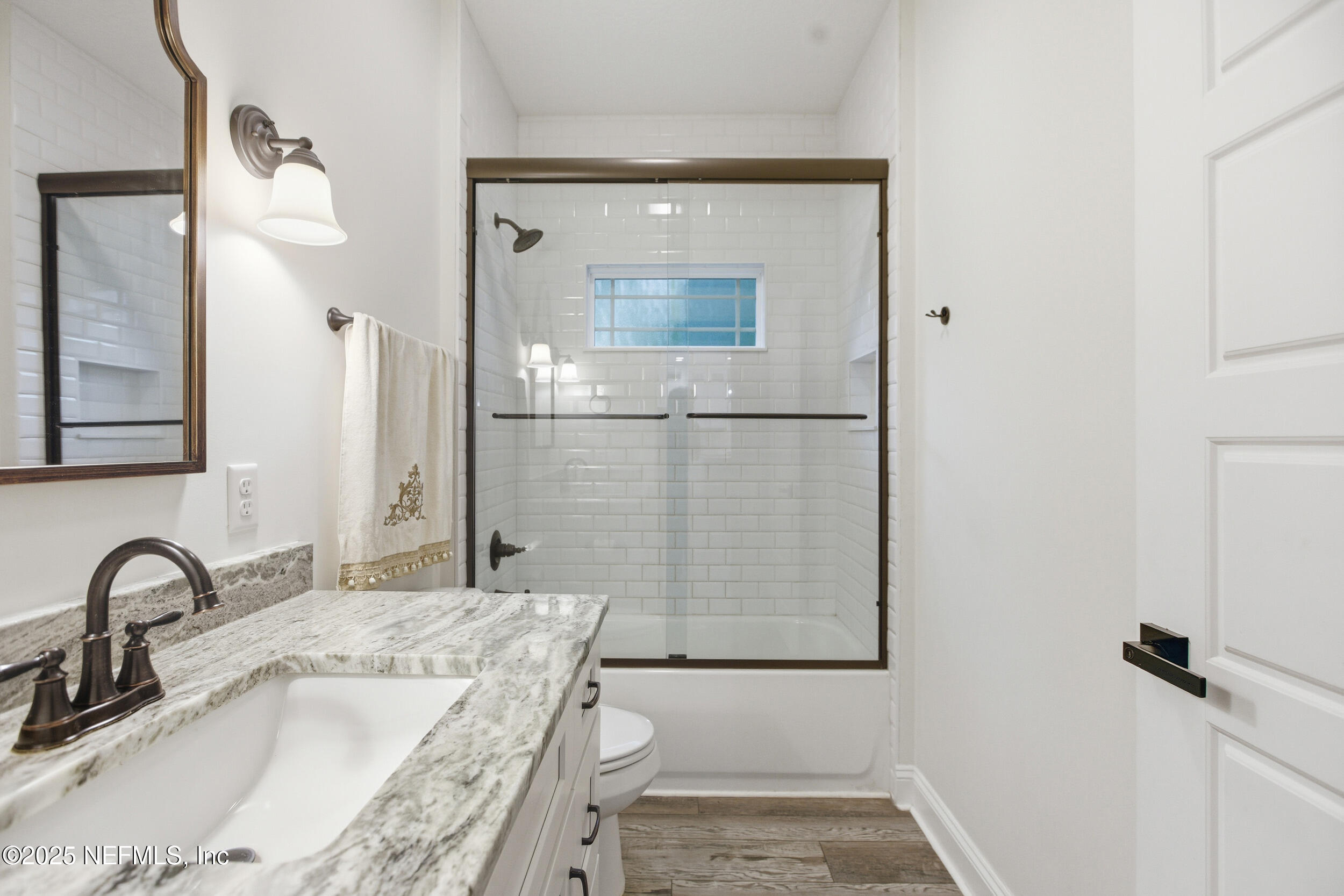 128 Santa Rosa Street Florahome, FL 32140 - Photo 9 of 57 a bathroom with a granite countertop sink a mirror and shower