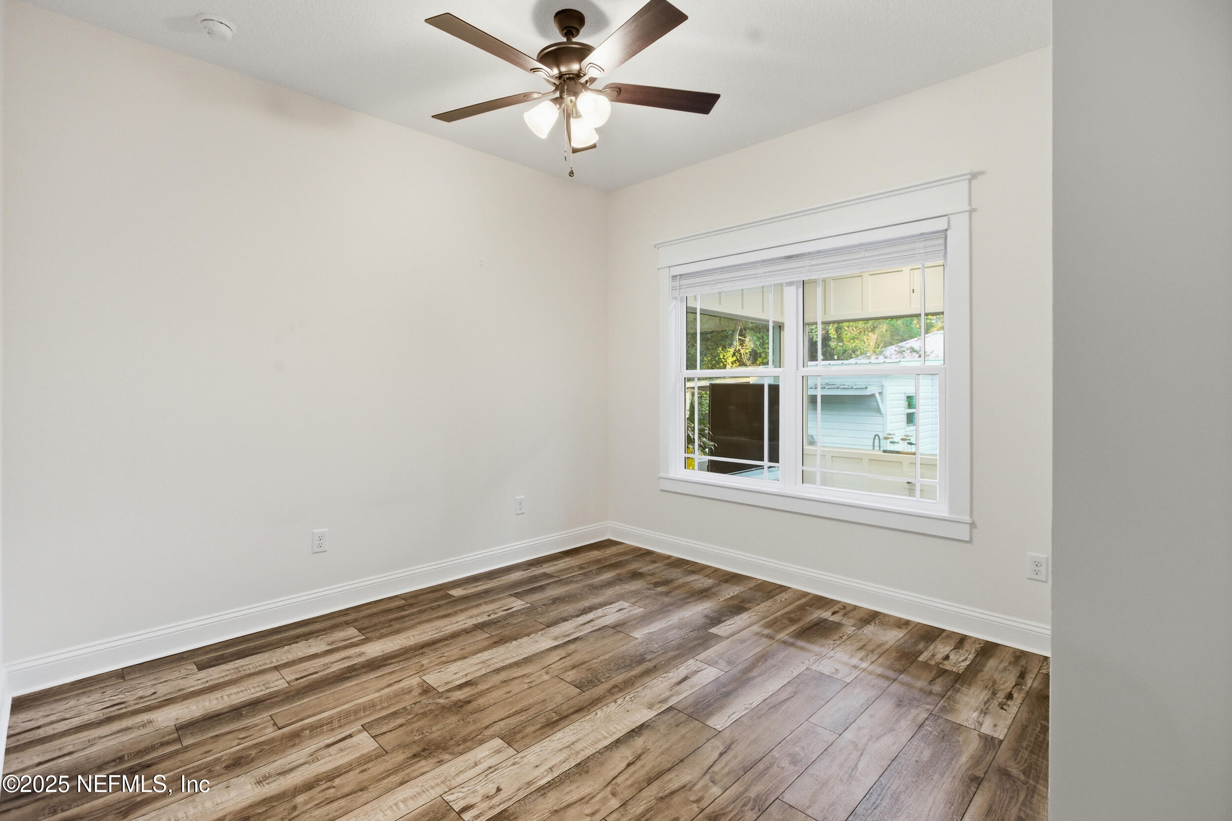128 Santa Rosa Street Florahome, FL 32140 - Photo 10 of 57 an empty room with a window and a ceiling fan