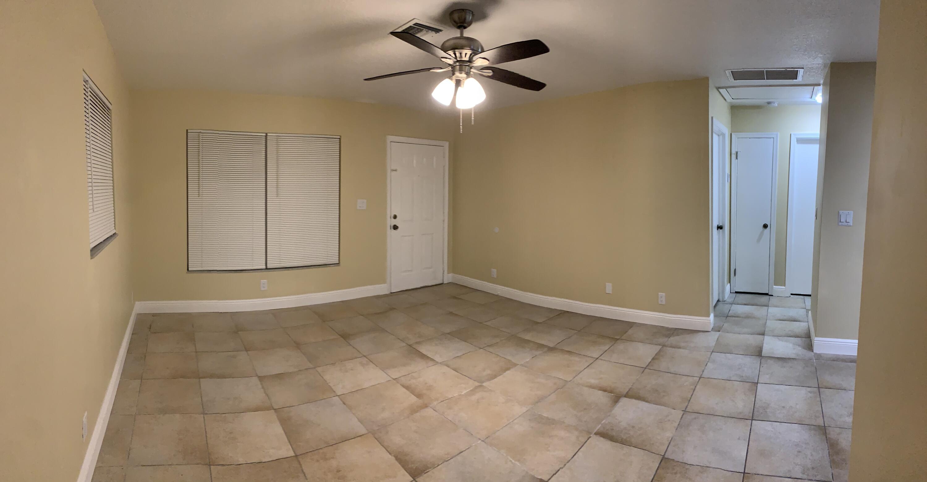 523 Colonial Road, Unit A B West Palm Beach, FL 33405 - Photo 6 of 11 a view of an empty room and chandelier fan
