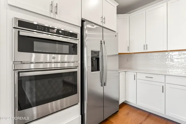 a kitchen with cabinets and stainless steel appliances