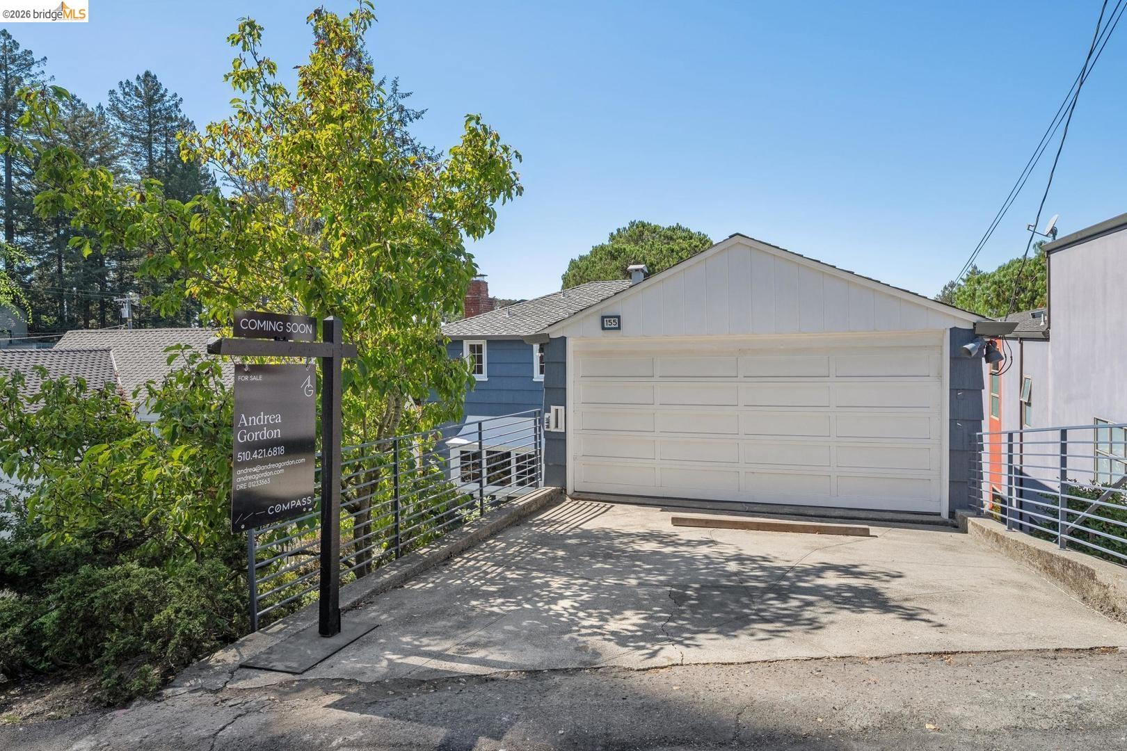 155 Avenida Drive Berkeley, CA 94708 - Photo 55 of 86 White panel garage door with a concrete driveway and metal railings