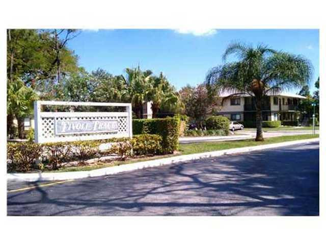 567 Trace Circle, Unit 110 Deerfield Beach, FL 33441 - Photo 3 of 8 a view of a house with a yard