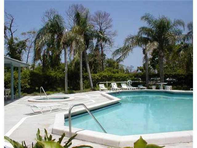567 Trace Circle, Unit 110 Deerfield Beach, FL 33441 - Photo 4 of 8 a swimming pool with outdoor seating and yard