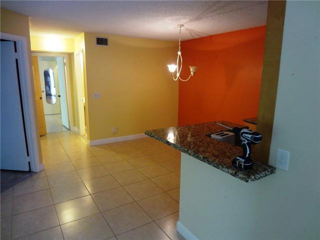 567 Trace Circle, Unit 110 Deerfield Beach, FL 33441 - Photo 5 of 8 a bathroom with a granite countertop sink and a mirror