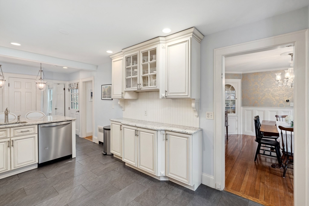 12 Cherry Lane Dedham, MA 02026 - Photo 14 of 37 a kitchen with white cabinets and sink