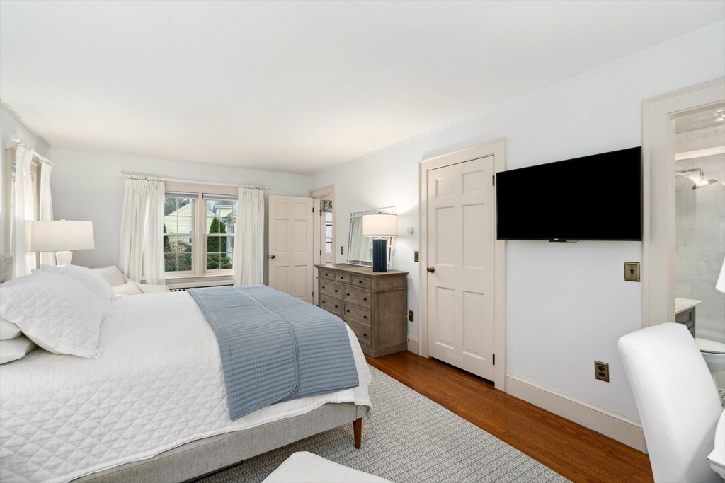 12 Cherry Lane Dedham, MA 02026 - Photo 17 of 37 a bedroom with a bed and a flat screen tv